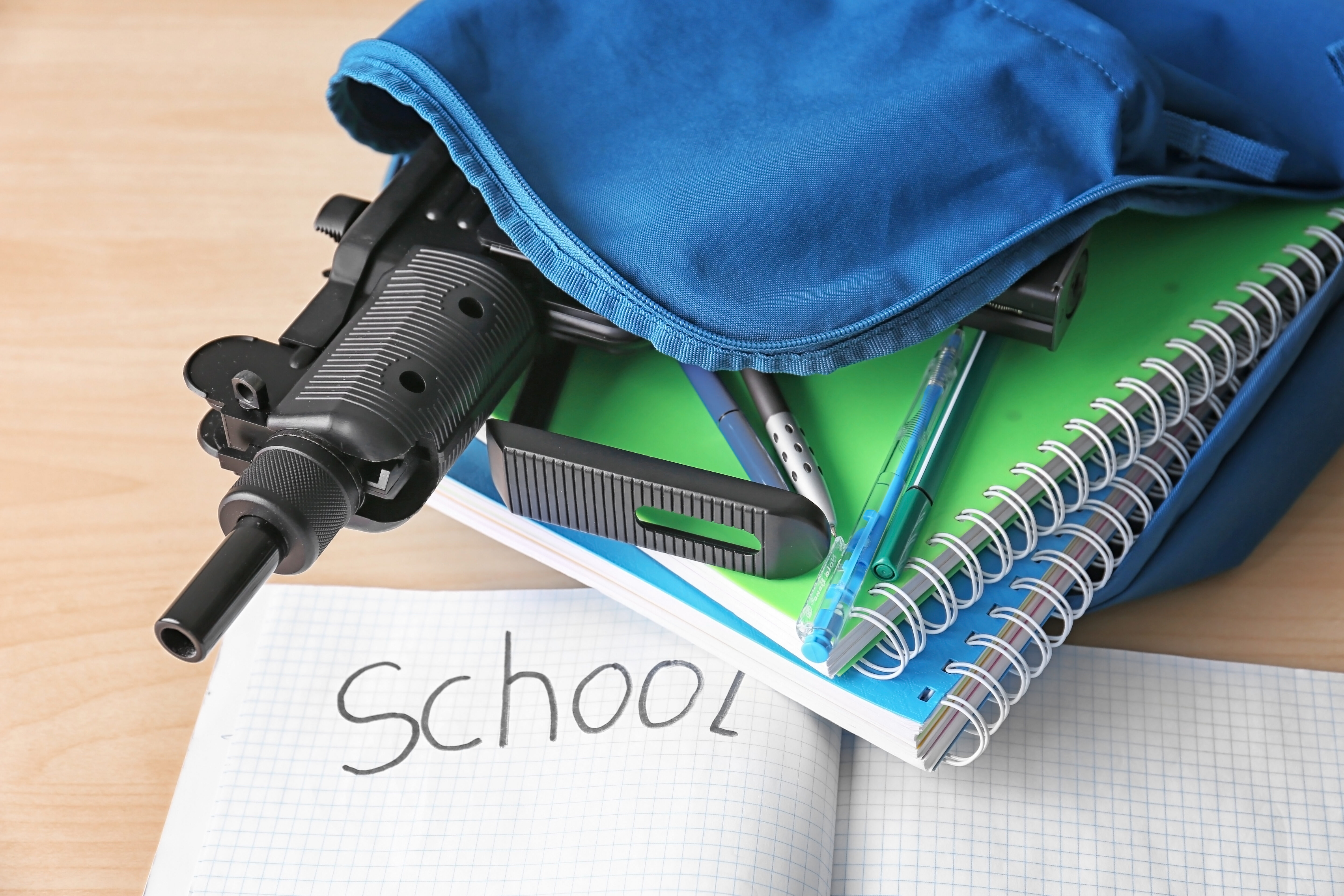 Gun in a bookback for an article about school shooters for successful black parenting