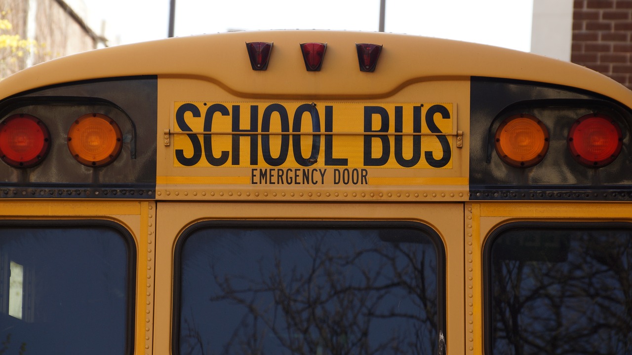 Photo of the back of a school bus, typically used in public schools