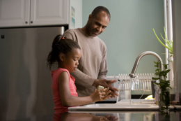 A dad with his daughter for an article on sickle cell anemia.