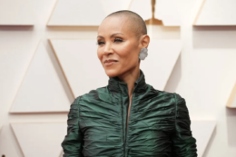 Slap, alopecia, hair loss - jada pickett-smith on the red carpet wearing green and a bald head.