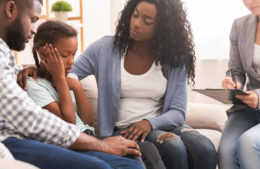 African american parents help their young child while teaching about your parenting style at psychologist consultation
