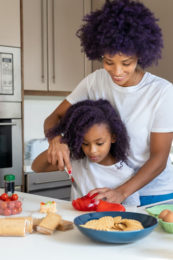 African american mom gets kids interested in cooking in the kitchen