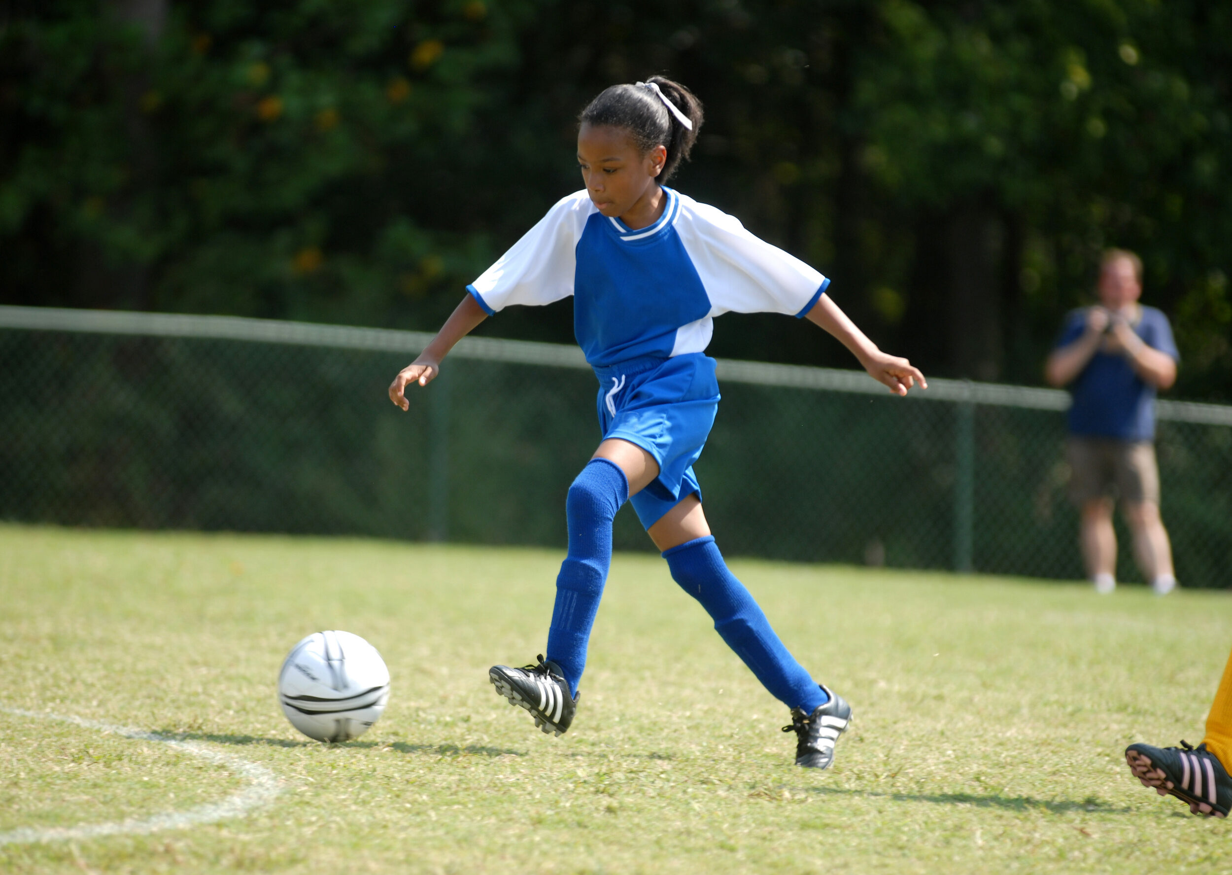 African american girl playing soccer with determination and developing her self-confidence through sports