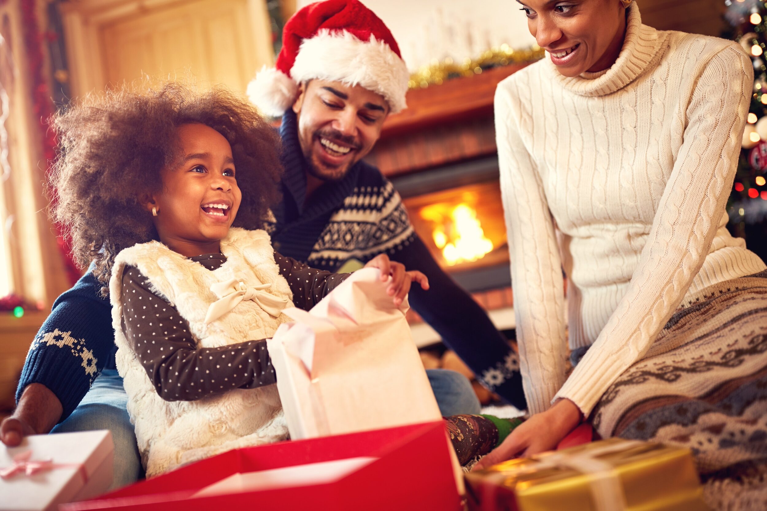 Stress free african american family opening holiday gifts with the kids for successful black parenting magazine.