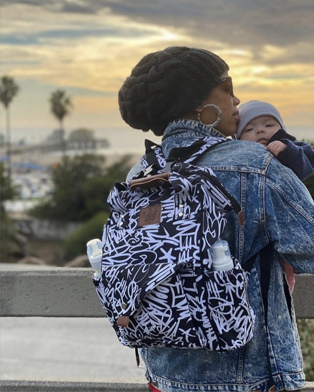Mom travels the city with her infant and her hip hop backpack.