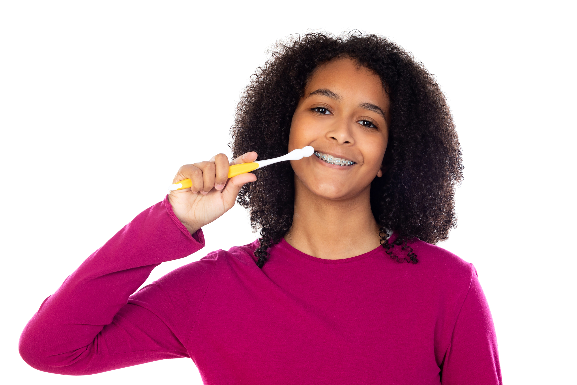 African american teenage girl brusher her teeth and has braces fun