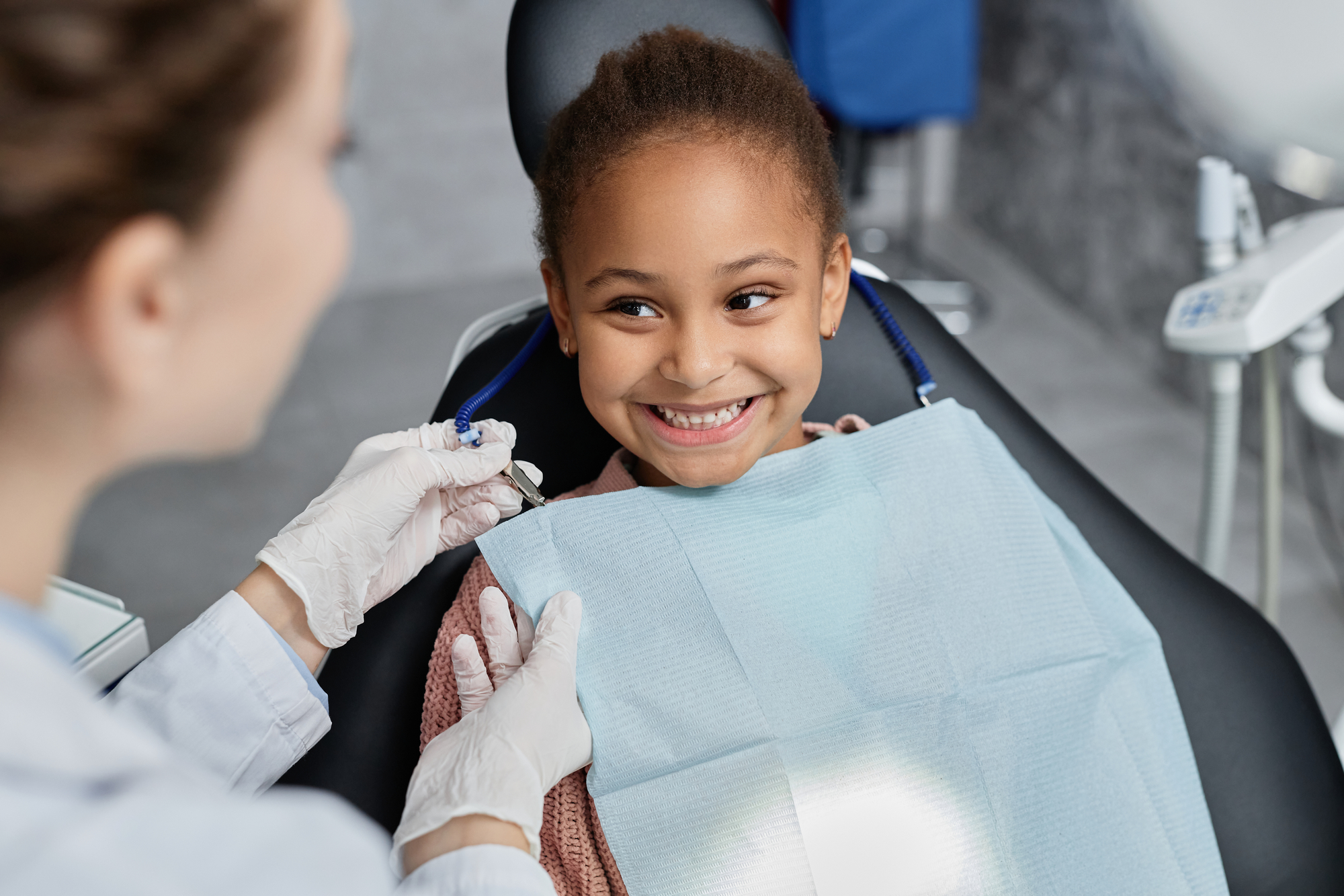 African american girl at dental office getting perfectly aligned teeth