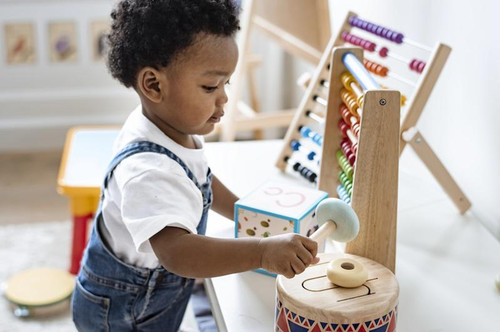 An african american toddler playing with montessori toys