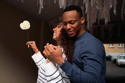 An african american couple with a rose practicing reconnect with your partner