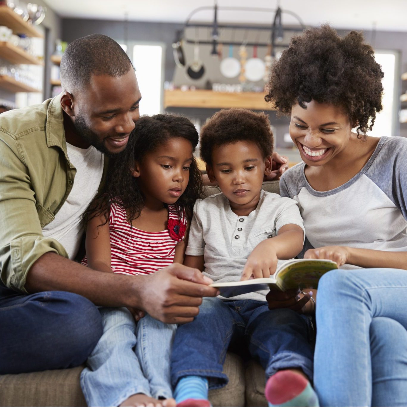 Black family read while learning how to discuss slavery with chldren.