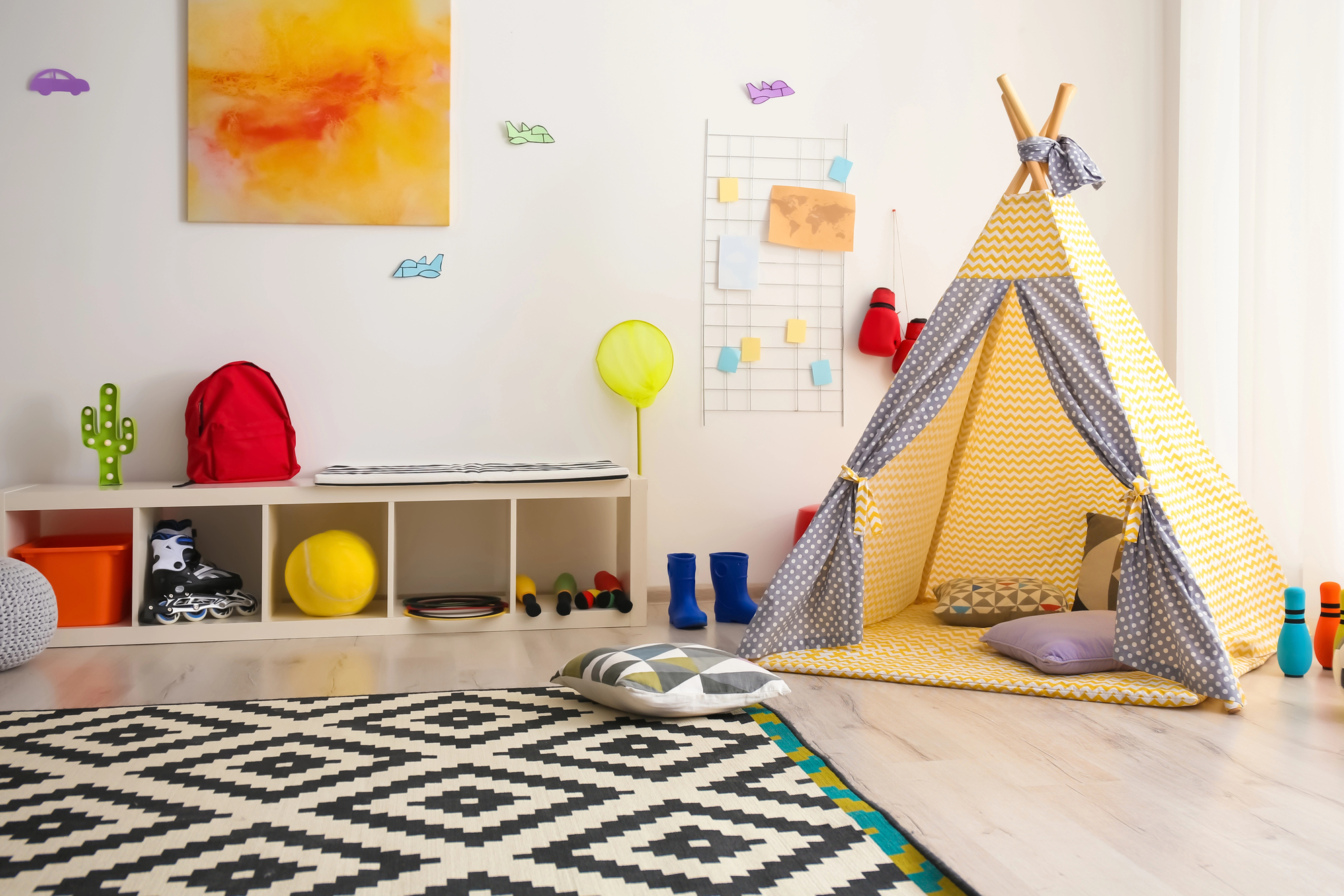 A child's bedroom decorated in bright colors like yellow and red to create a bedroom your kids will adore