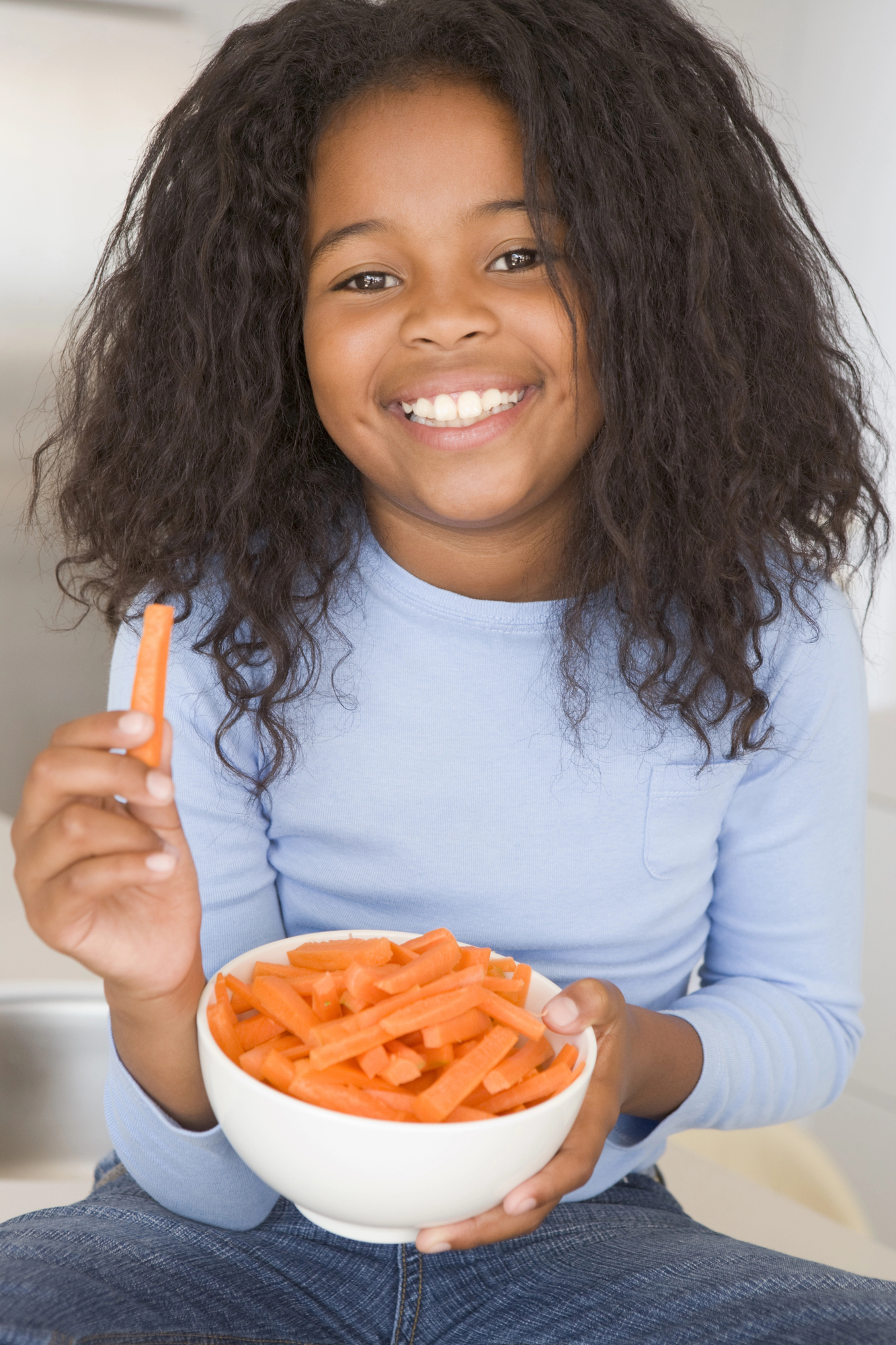 African american girl showing health eating habits for an article on fun cooking activities for kids.