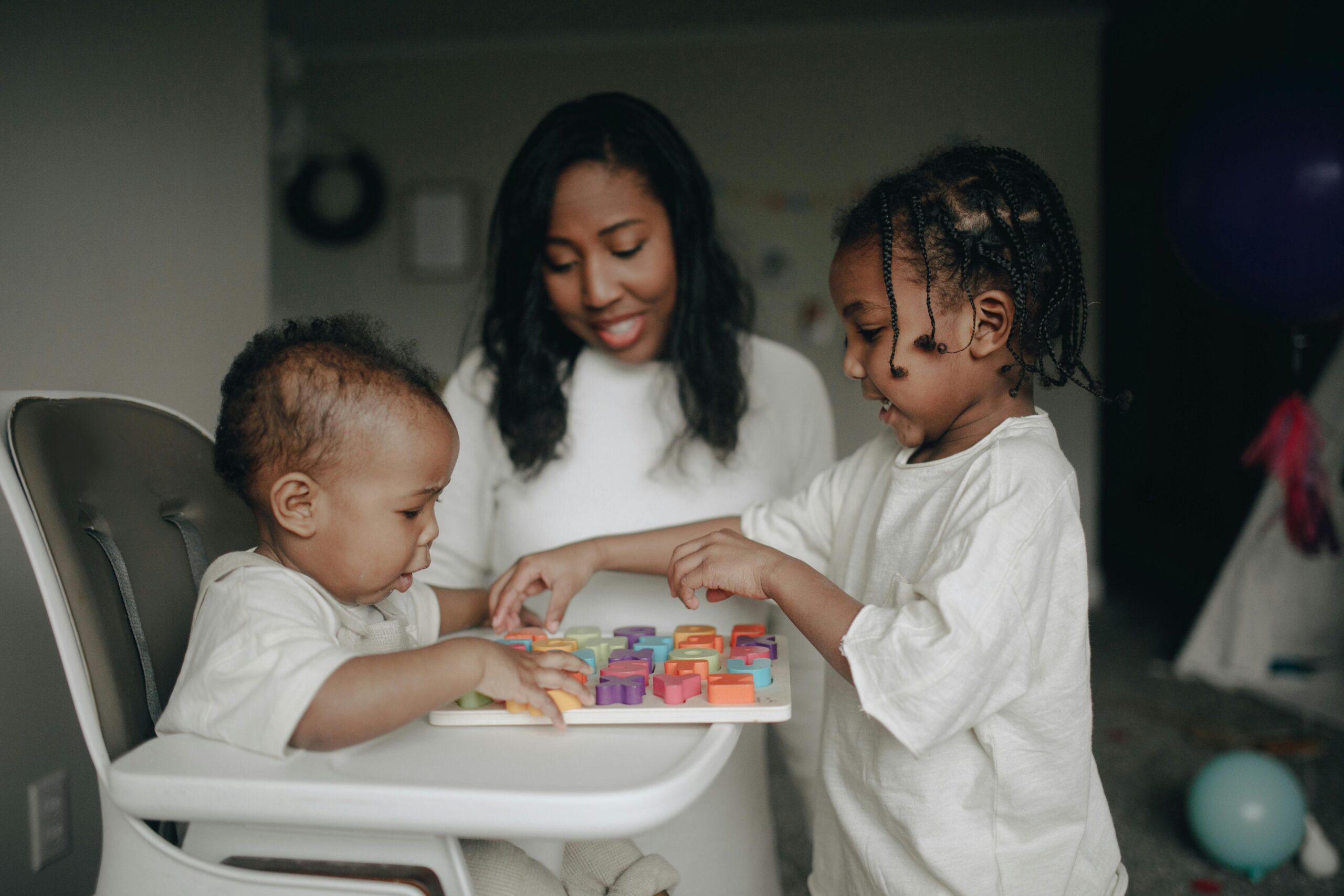 Mom and kids playing blocks to prepare her child for kindergarten.