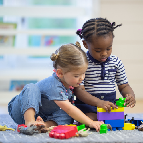 Two children with autism play with lego blocks.