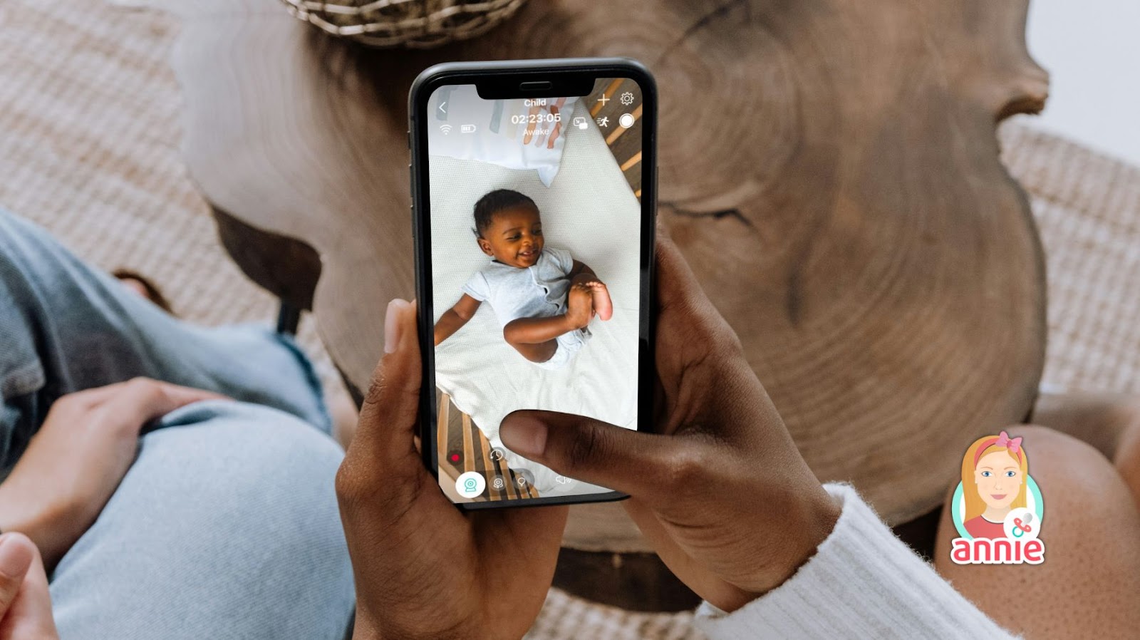 An african american baby is in the bed being watched on a baby monitor.