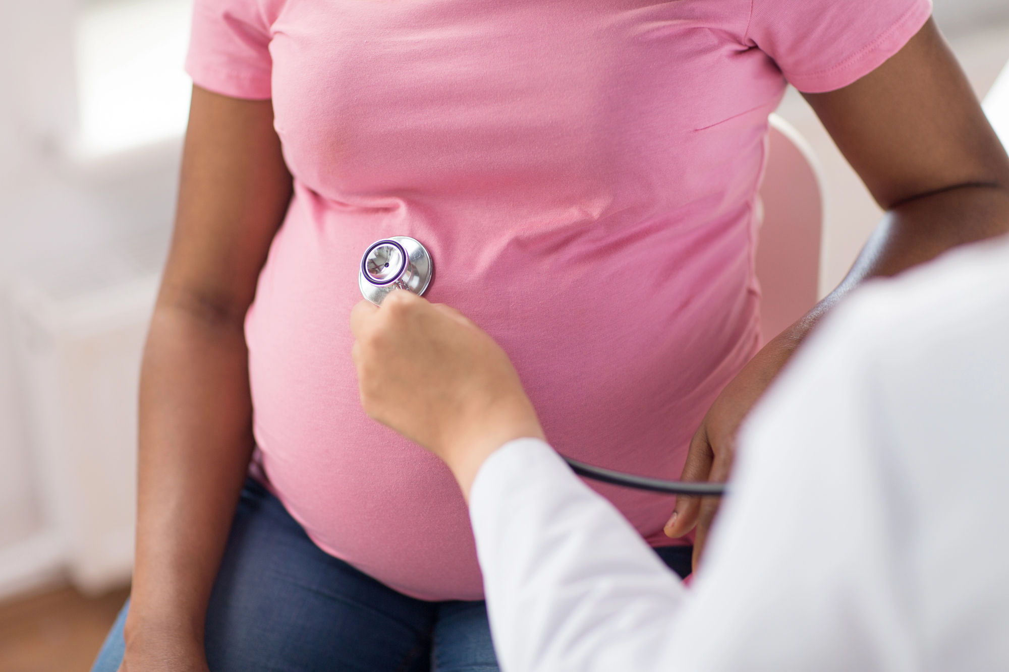 A pregnant african american woman getting an exam for understanding birth injuries in black families: awareness and support
