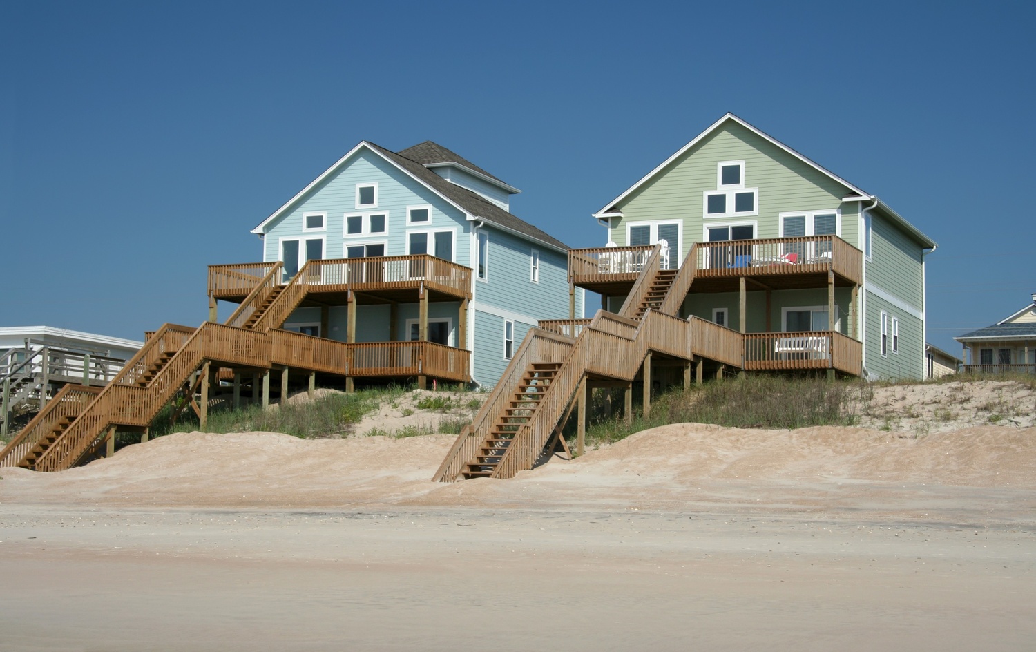 Beachfront family vacation home with elevated wooden decks overlooking the ocean.