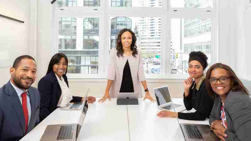 Black executives in corporate meeting discussing working parent crisis and corporate support policies for working parents