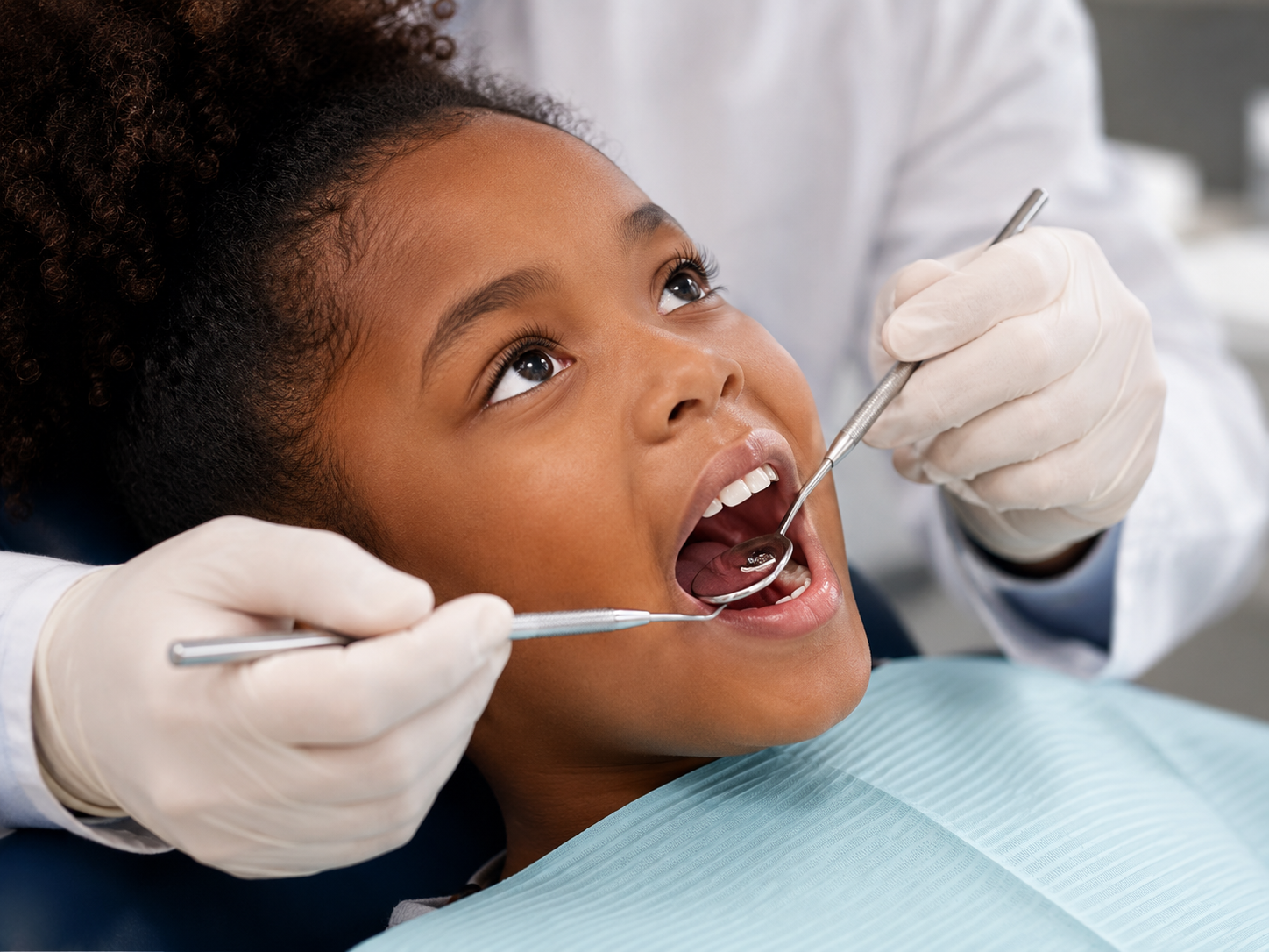 African american girl receiving a pediatric dental exam during a routine children's dental checkup in a modern dental office for children's dental health.
