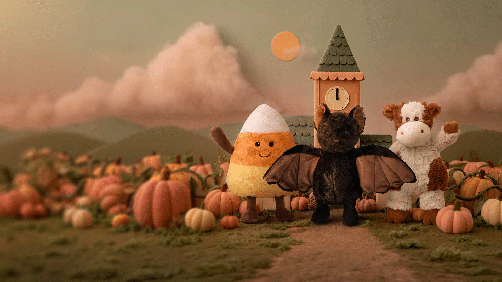 Warmies plush characters in a pumpkin patch at sunset, including a black bat and giraffe, for a cozy toddler bedtime routine.
